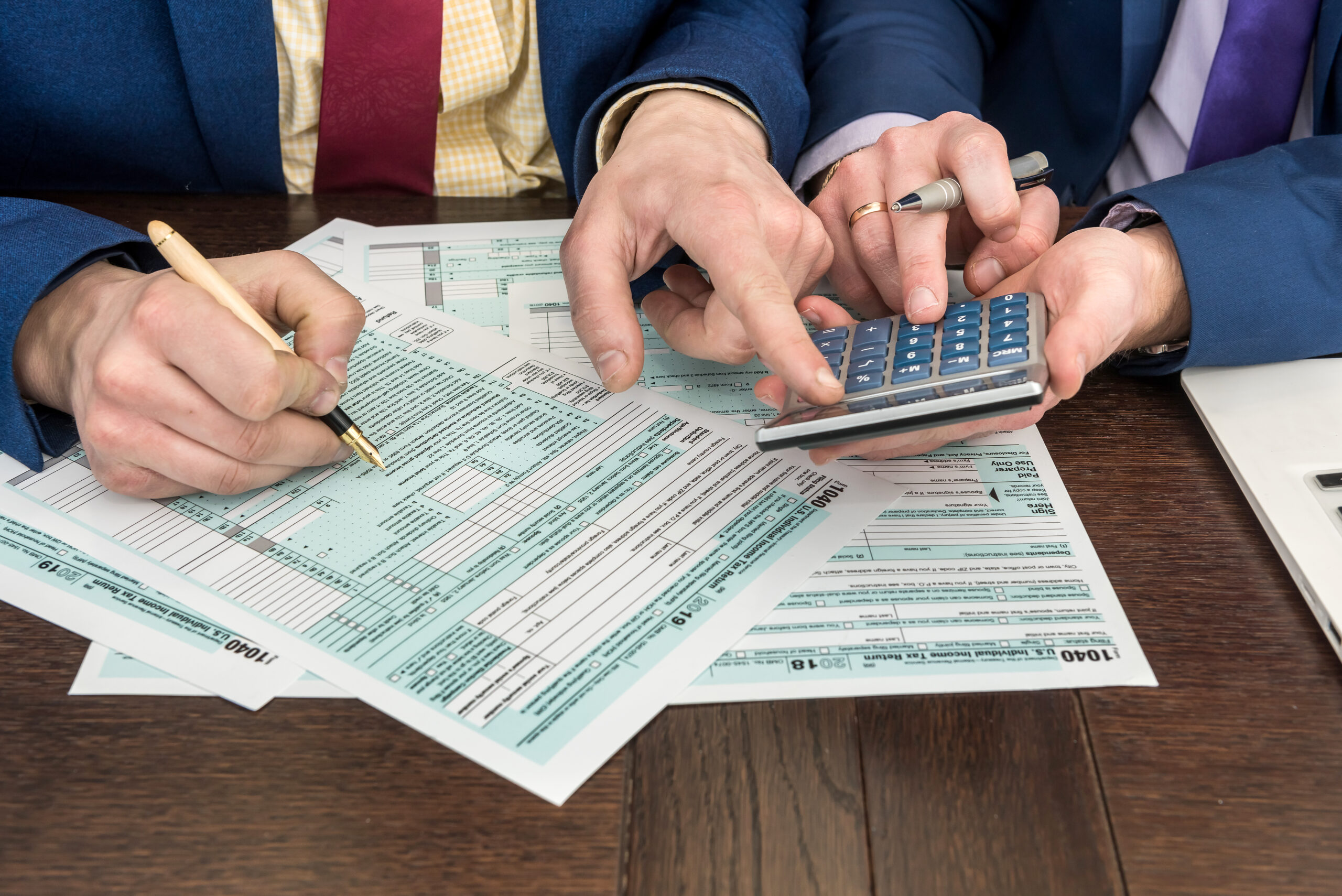 Accountant fills in tax form. Businessman accounting finance document. Paperwork, time for tax.