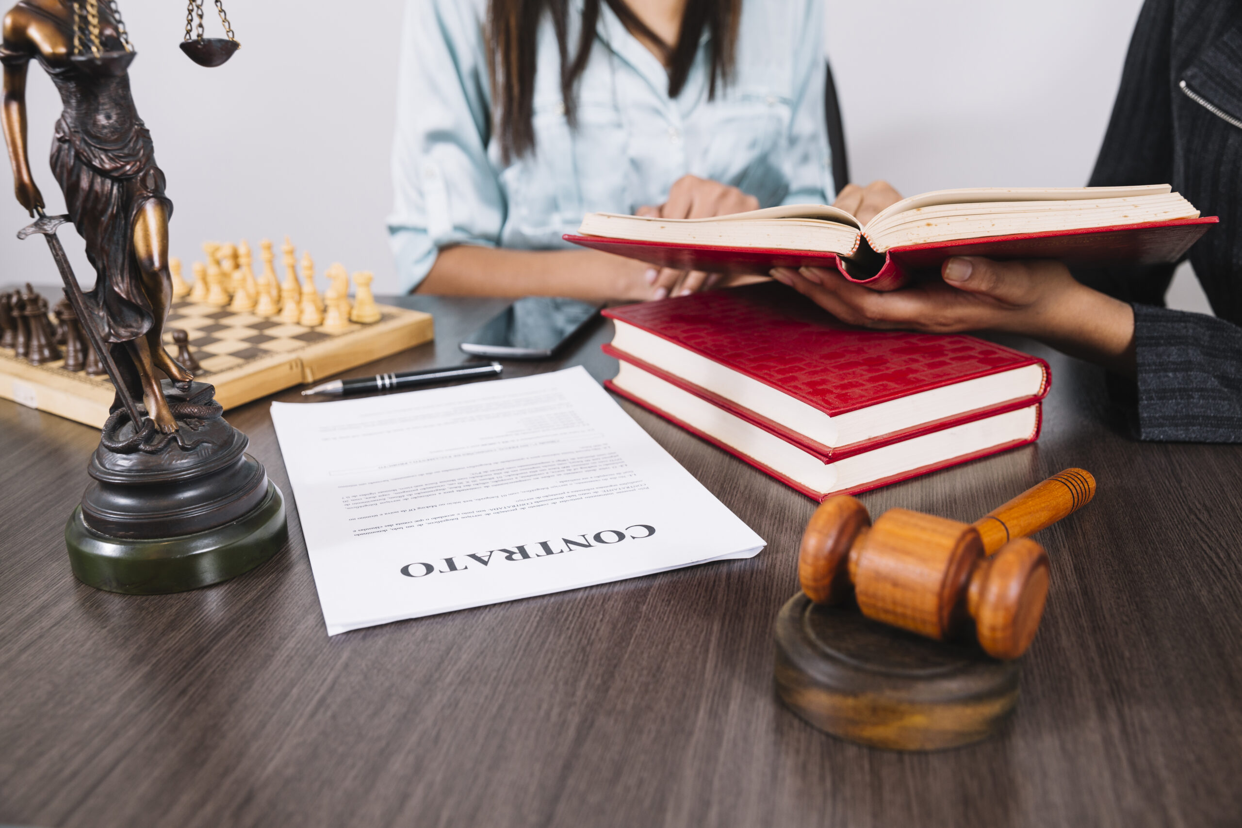 women-with-books-table-with-smartphone-statue-document-chess