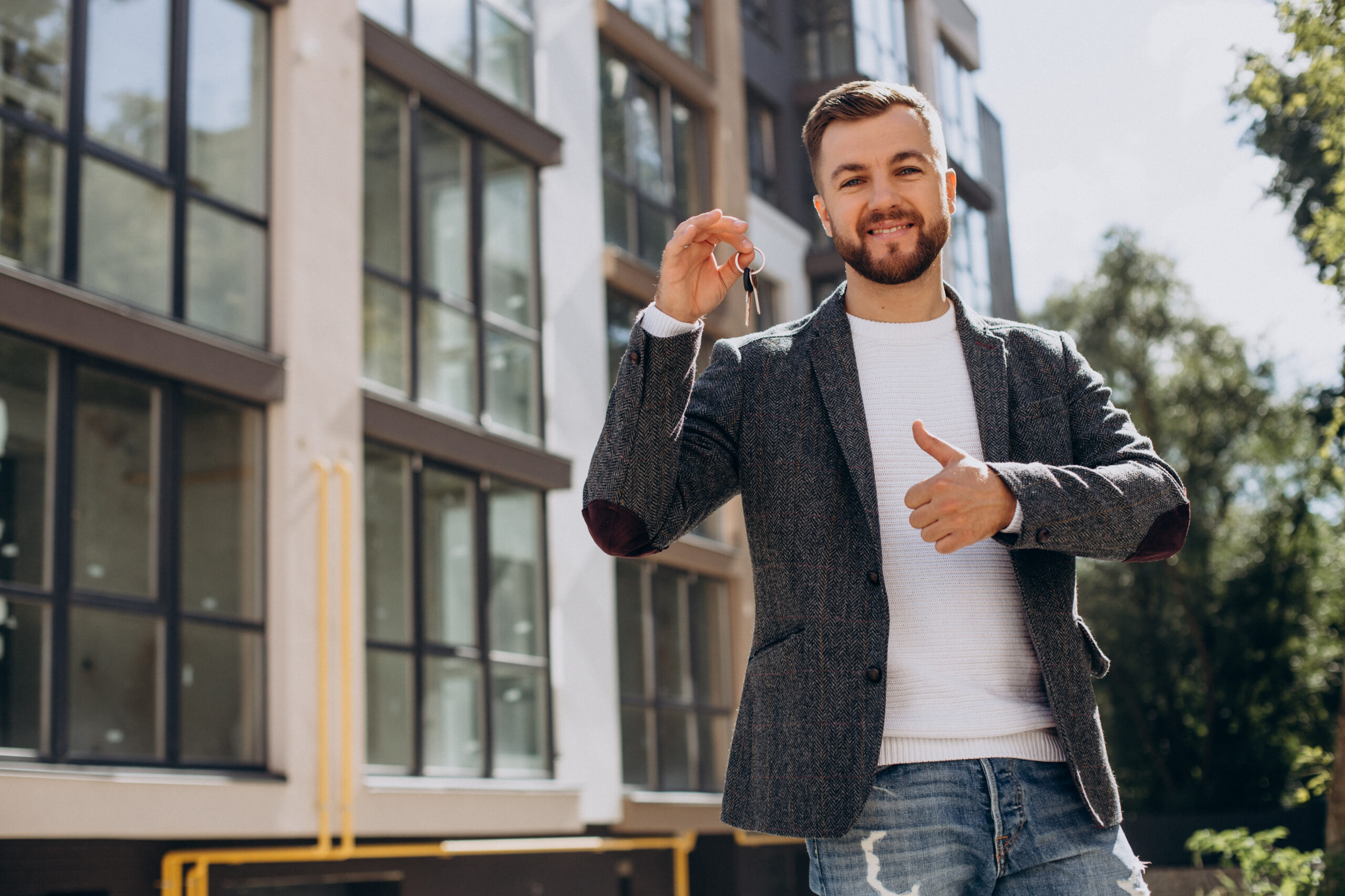 Young man with keys just bought new appartment