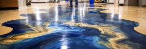 Suelo de epoxi metálico azul y dorado con pies de persona en un moderno edificio