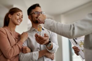 primer-plano-de-un-agente-de-bienes-raices-dando-un-par-de-llaves-de-su-nuevo-hogar